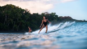 Woman surfing in Pavones at one of the best beginner surf spots in Costa Rica