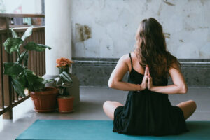 Lady getting fit for surfing by doing a yoga pose