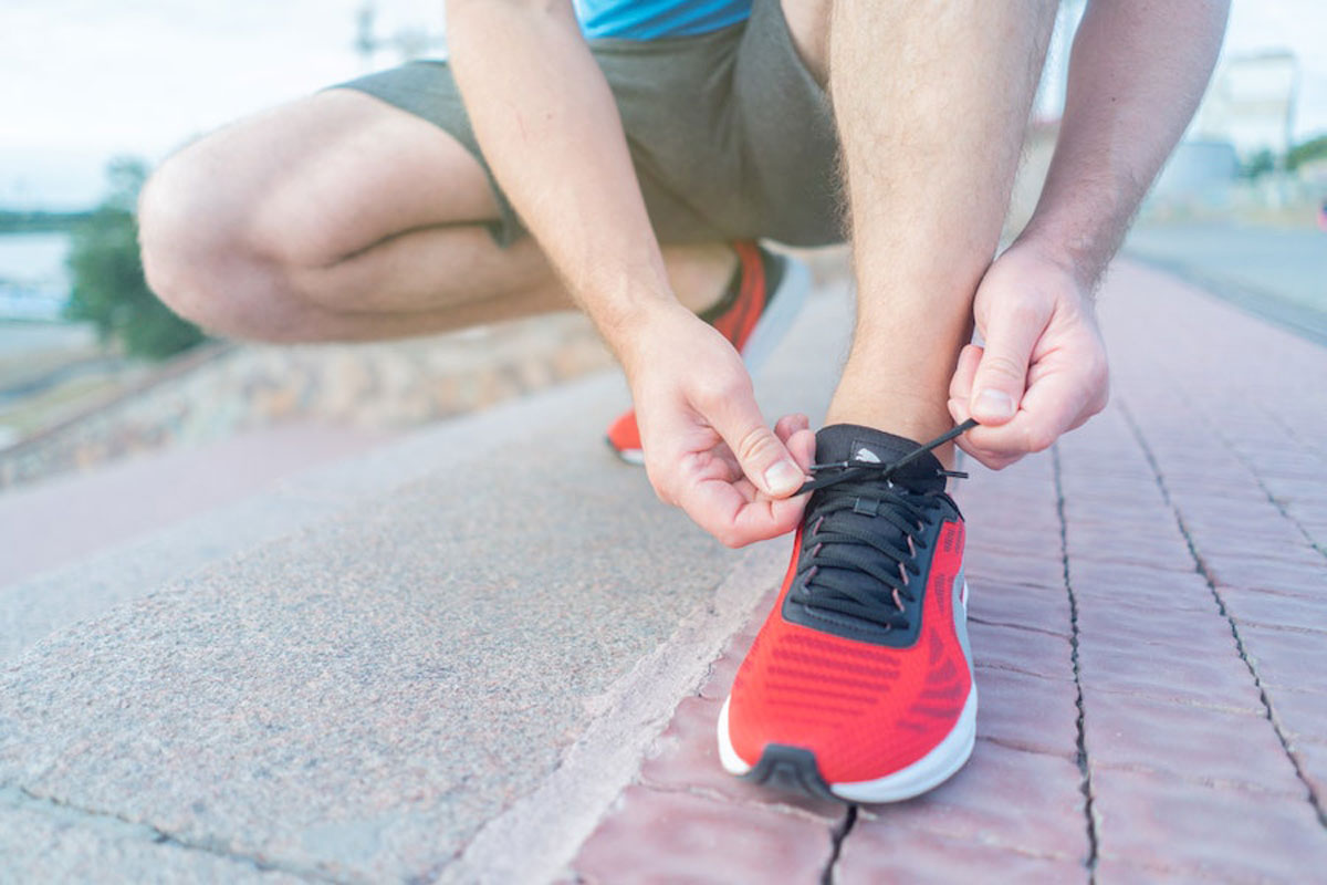 Man lacing up his trainers in preparation for a run