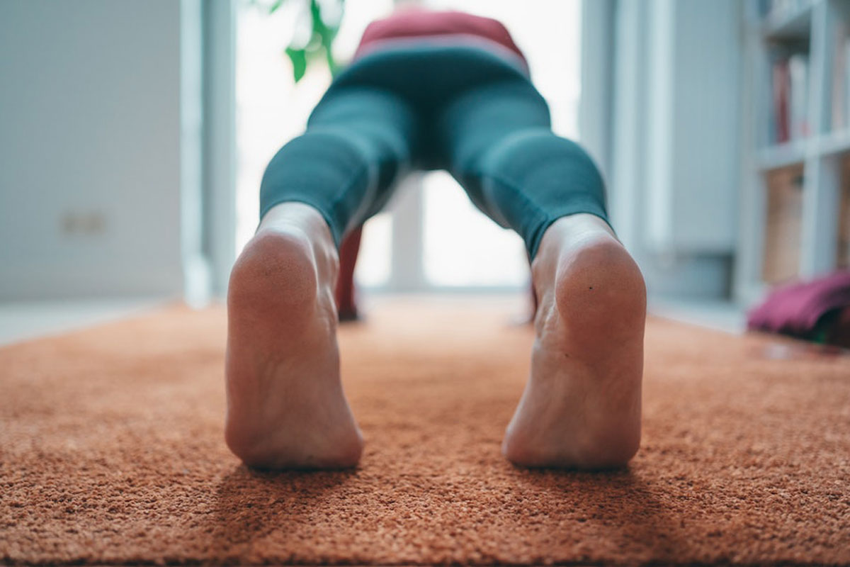 Woman getting fit for surfing by doing a pushup