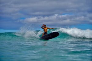 Surfer turning a longboard surfboard on the wave