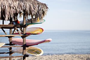 Longboards stacked one on top of another in a beach shack
