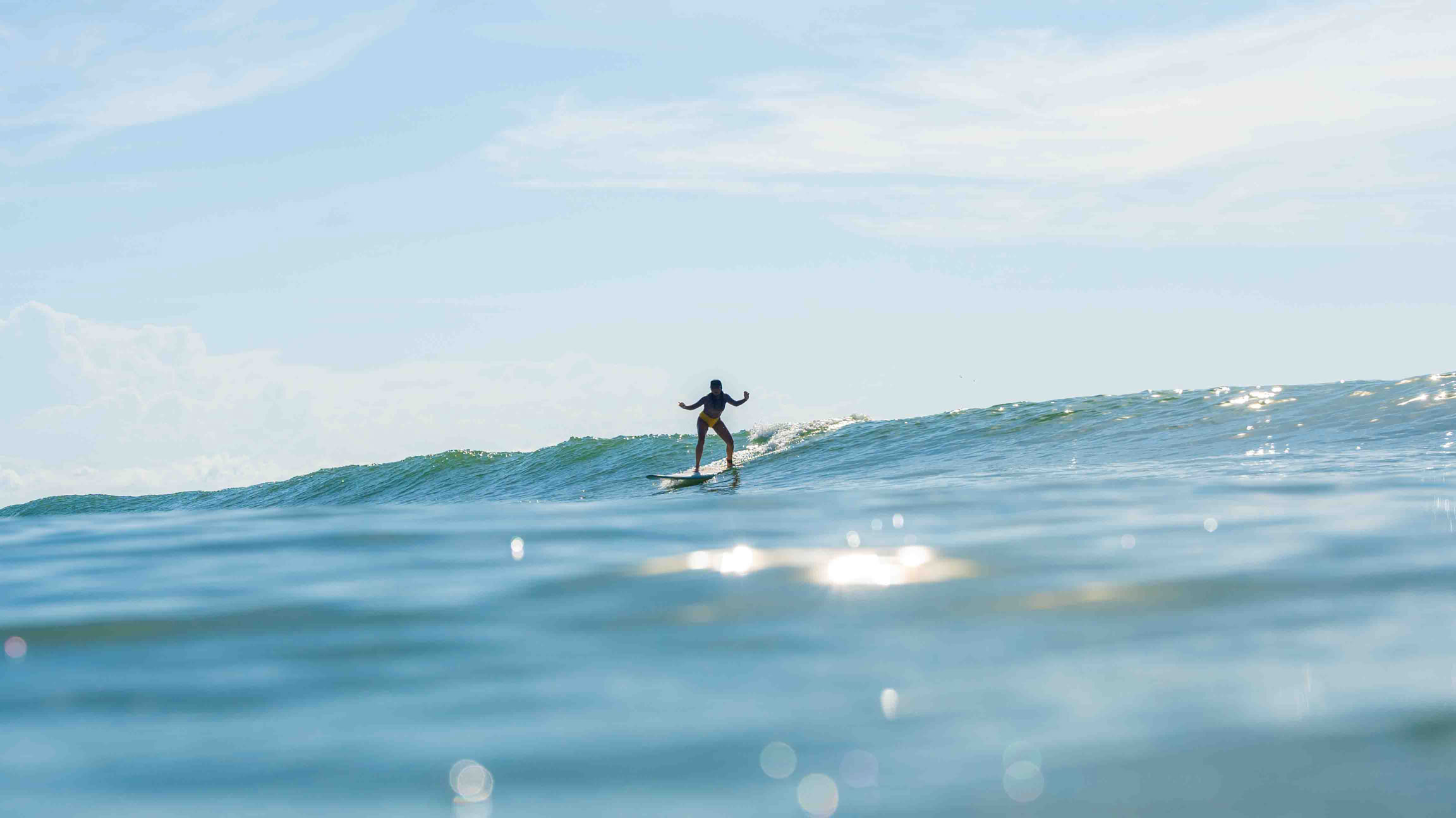 A surfer enhancing flexibility and balance while surfing.