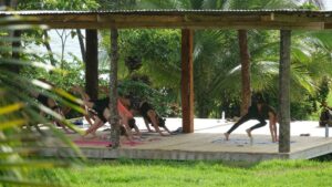 Practicing Yoga at the oceanfront yoga shala at Surf Expedition